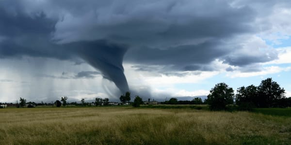 tornado forming over open field