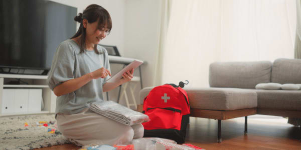 woman preparing emergency tornado supplies kit