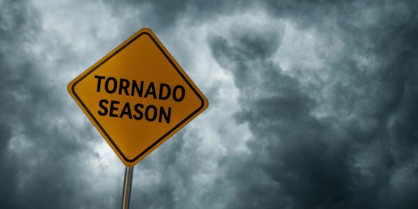 tornado season sign in front of stormy clouds