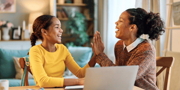 mother and daughter high-fiving