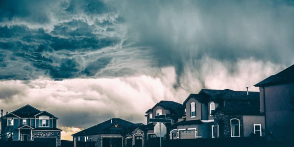 intense storm clouds over neighborhood homes