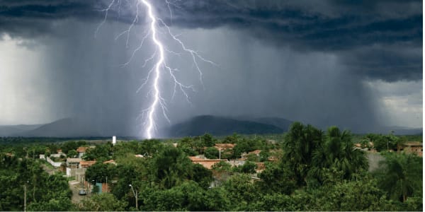 bolt of lighting during thunderstorm over neighborhood