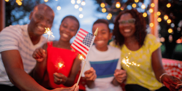happy family celebrating America's 250th birthday with flags