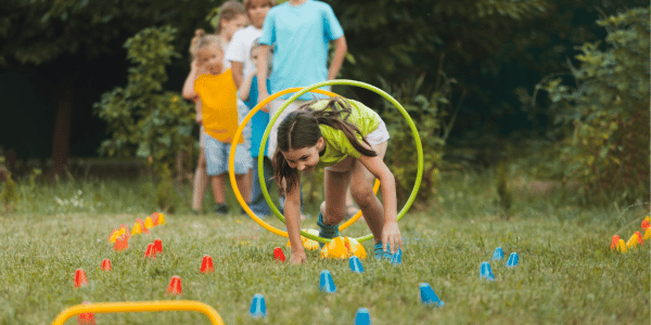 group of children playing backyard games in summer