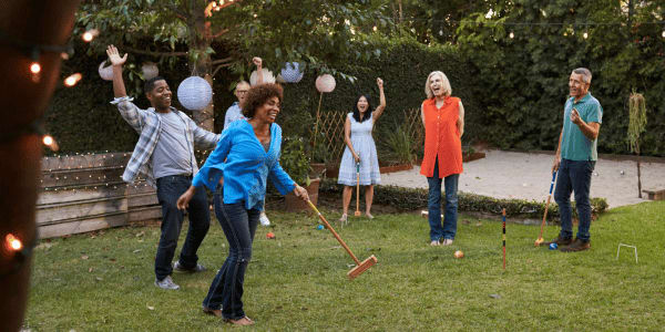 family playing croquet in the backyard