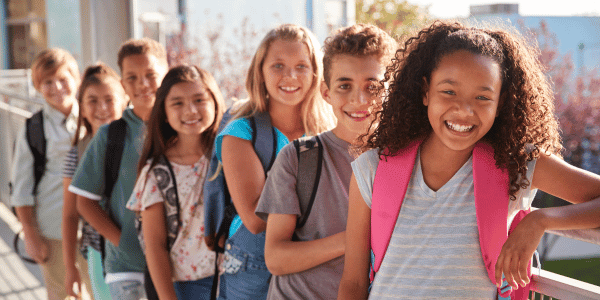 group of students smiling on first day of school