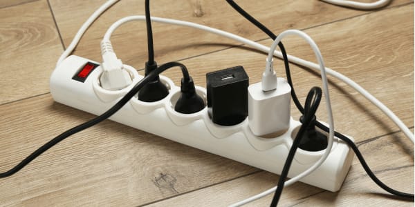 messy cables and cords plugged into power strip