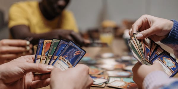 people playing a trading card game