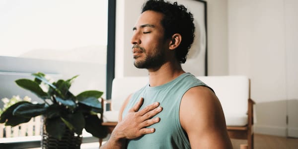 man practicing breathing techniques