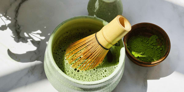 matcha tea with whisk on countertop