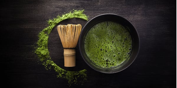 matcha whisk and bowl on black table