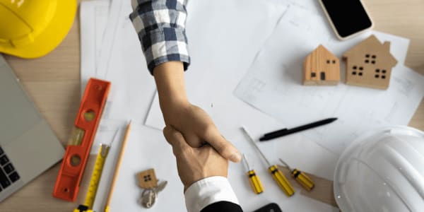 two people shaking hands after completing a home inspection