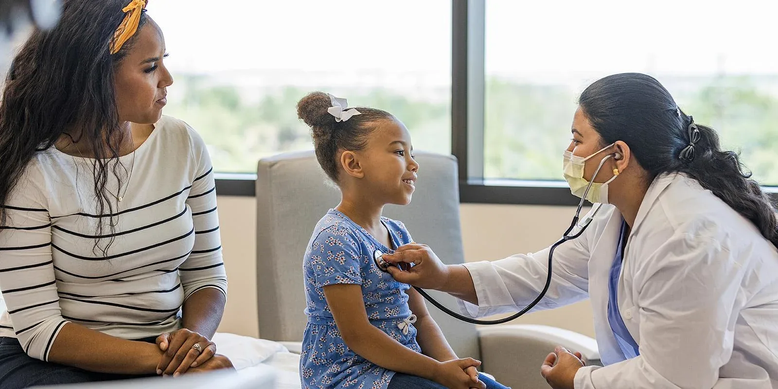 Doctor with woman and daughter