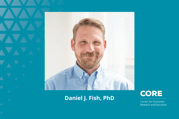 A headshot of Daniel J Fish smiling facing the camera