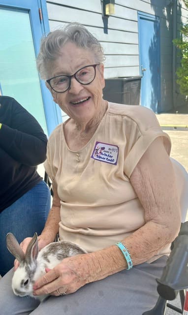  Resident Carole Parkinson (white shirt) snuggles a bunny during the Emilie House 40th Anniversary celebration.