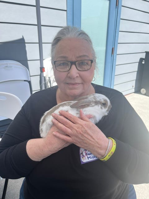 Resident Jeanne Plumb (black shirt) snuggles a bunny during the Emilie House 40th Anniversary celebration. 
