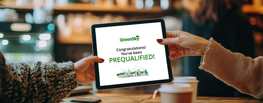 Two people holding an iPad with a prequalification screen from GreenSky
