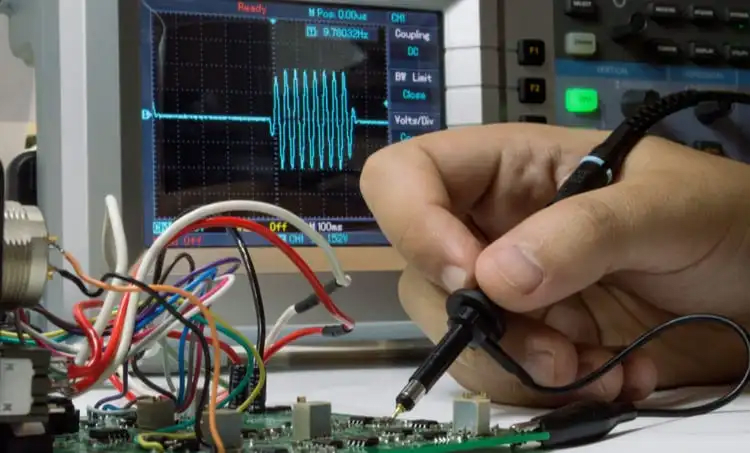 PCB being probed through the utilization of an oscilloscope