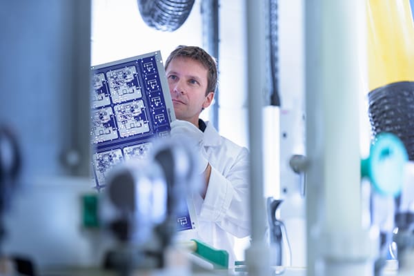 worker-inspecting-circuit-board-by-processing-plan-2024-10-18-09-50-19-utc_pvulmb