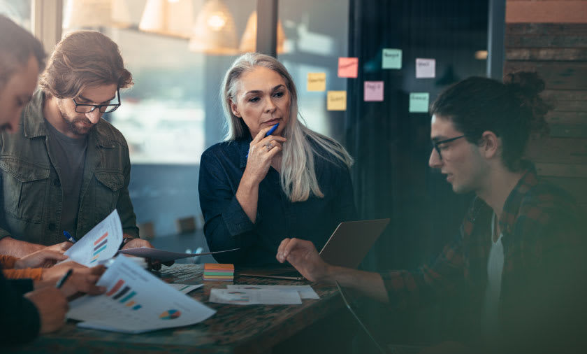 a pair of CEOs and finance leaders in meeting
