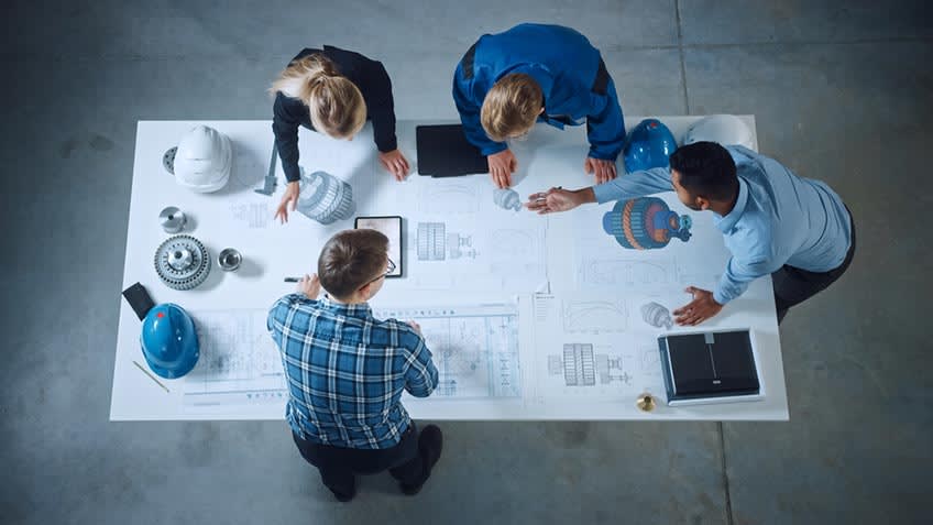 manufacturing leadership in meeting looking at options to increase output via outsourcing