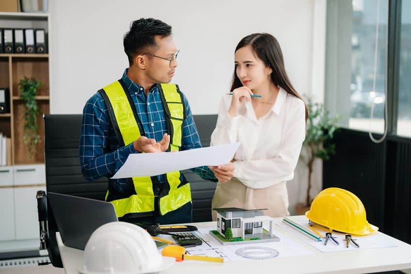 manufacturing worker and finance vp discussing the benefits of outsourcing