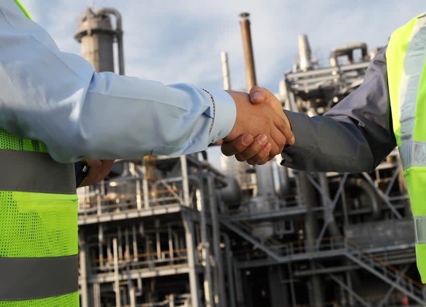 oil and gas CFO shaking hands with outsourced accounting company representative