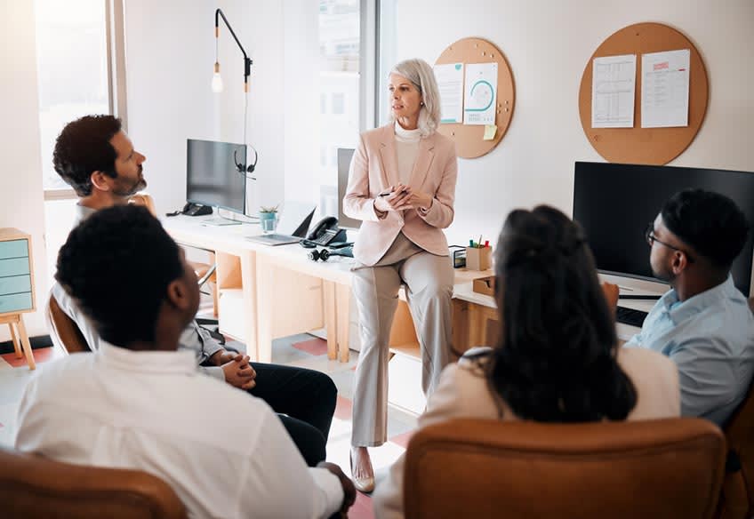 Finance director discussing the benefits of outsourcing with her team