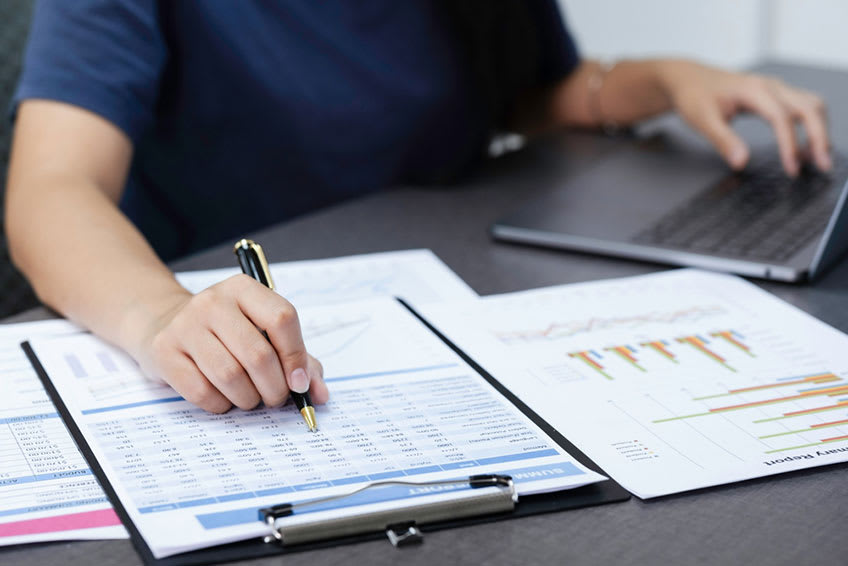 financial leader comparing costs to see if financial outsourcing investment was worth it