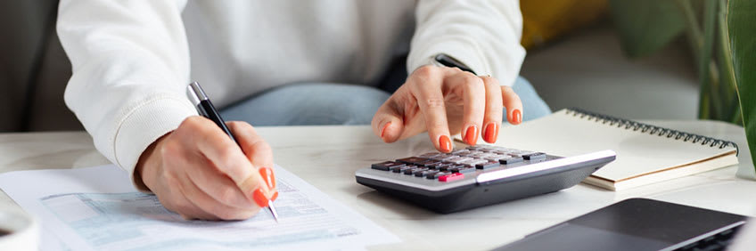 CFO calculating how much it would save her company to outsource their CPA service needs