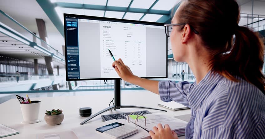Business owner looking at the cost in a contract by AP automation company to combat various challenges