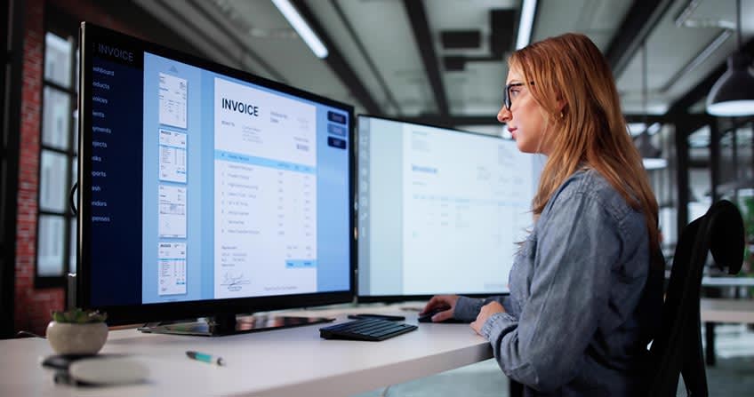 Finance director reviewing invoices sent by her bookkeeping staff