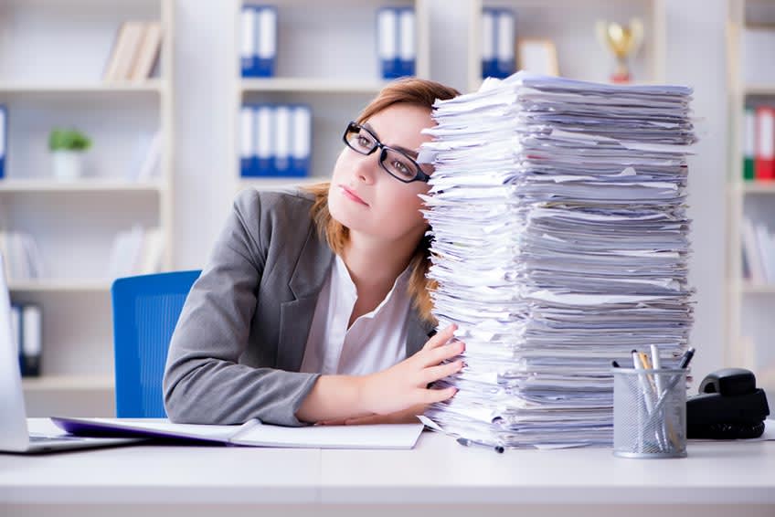 Stressed bookkeeper overwhelmed by amount of work