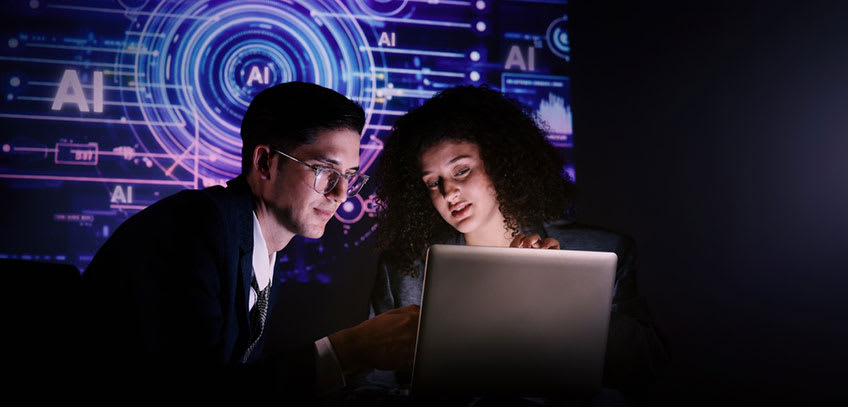 Hybrid AI outsourcing company representatives setting up dashboard for client