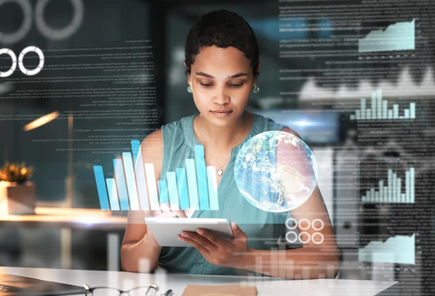 Woman checking work of her hybrid team at the end of the day with futuristic graphics overlay