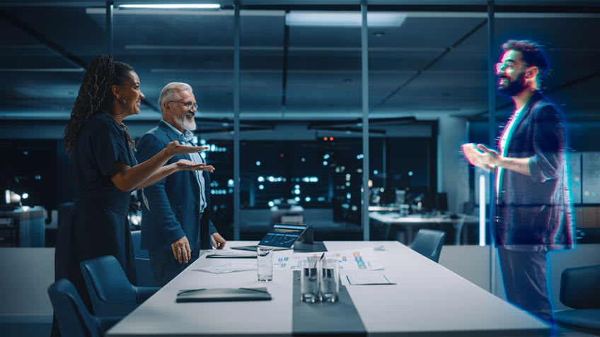 CFO and Finance VP in regular session with hybrid AI outsourcing partner illustrated as hologram