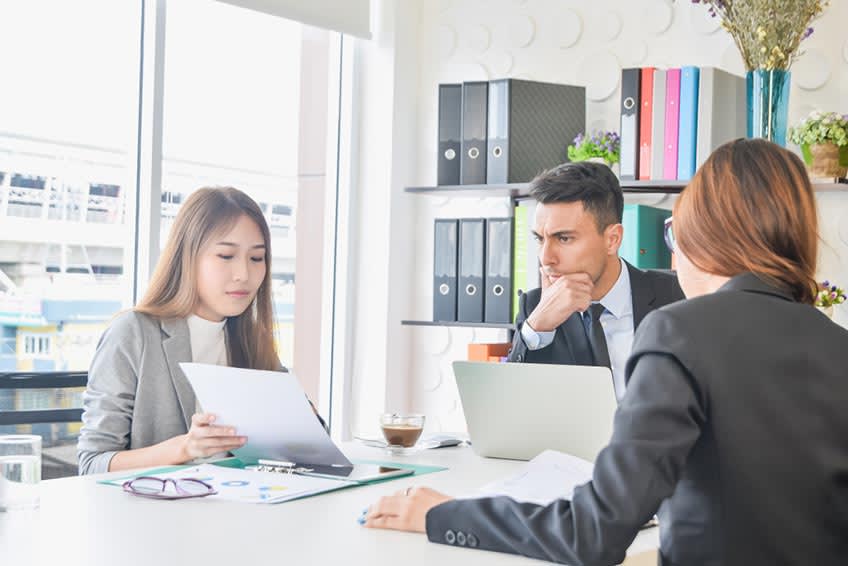 CFO checking updated report on delegated tasks to AI with his accounting team