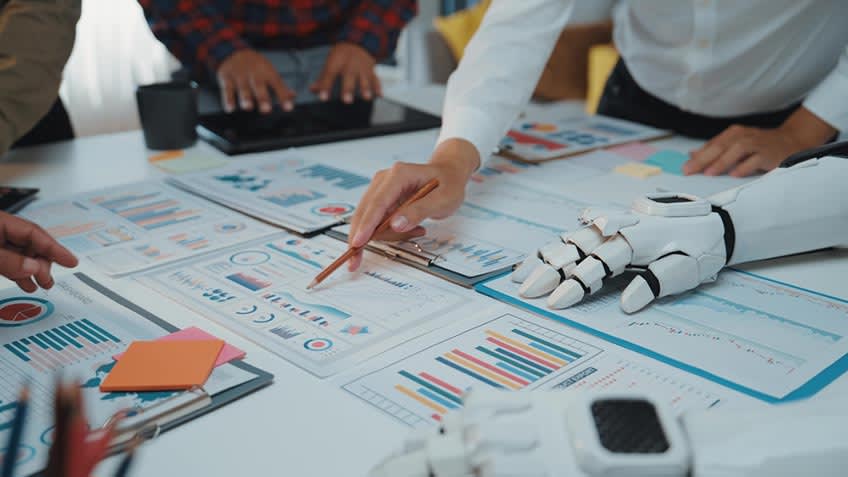 Illustration of team of accountants instructing AI what it should automate