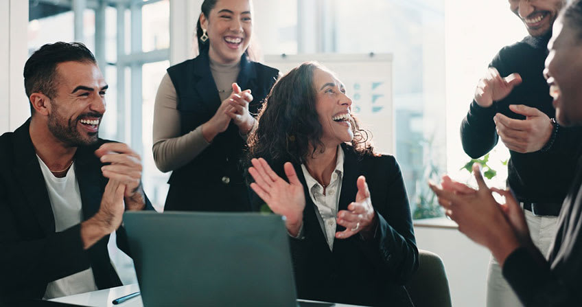 Accounting team clapping for successfully hitting financial goals