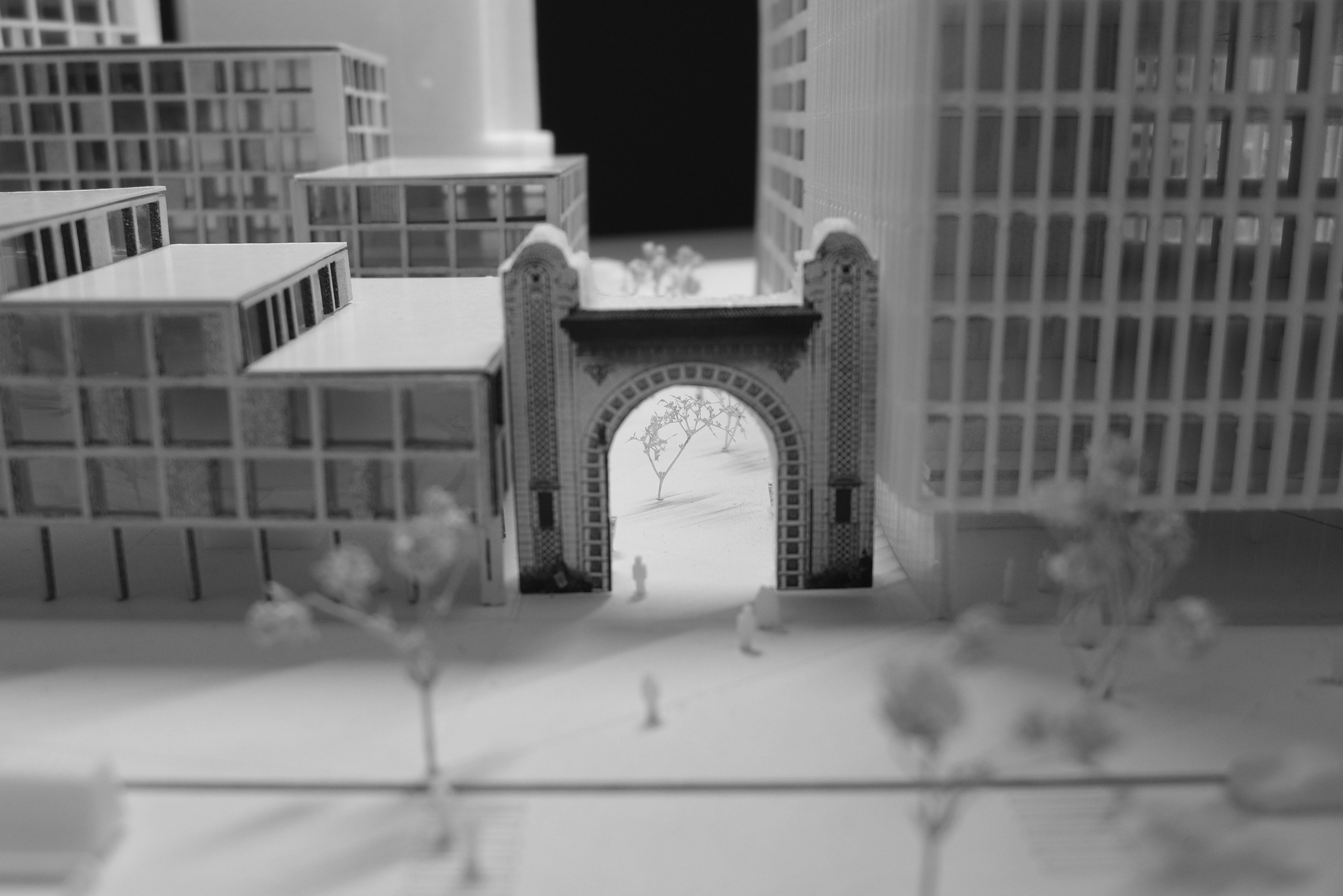 A 3D-printed model showing buildings and an outdoor space with trees.