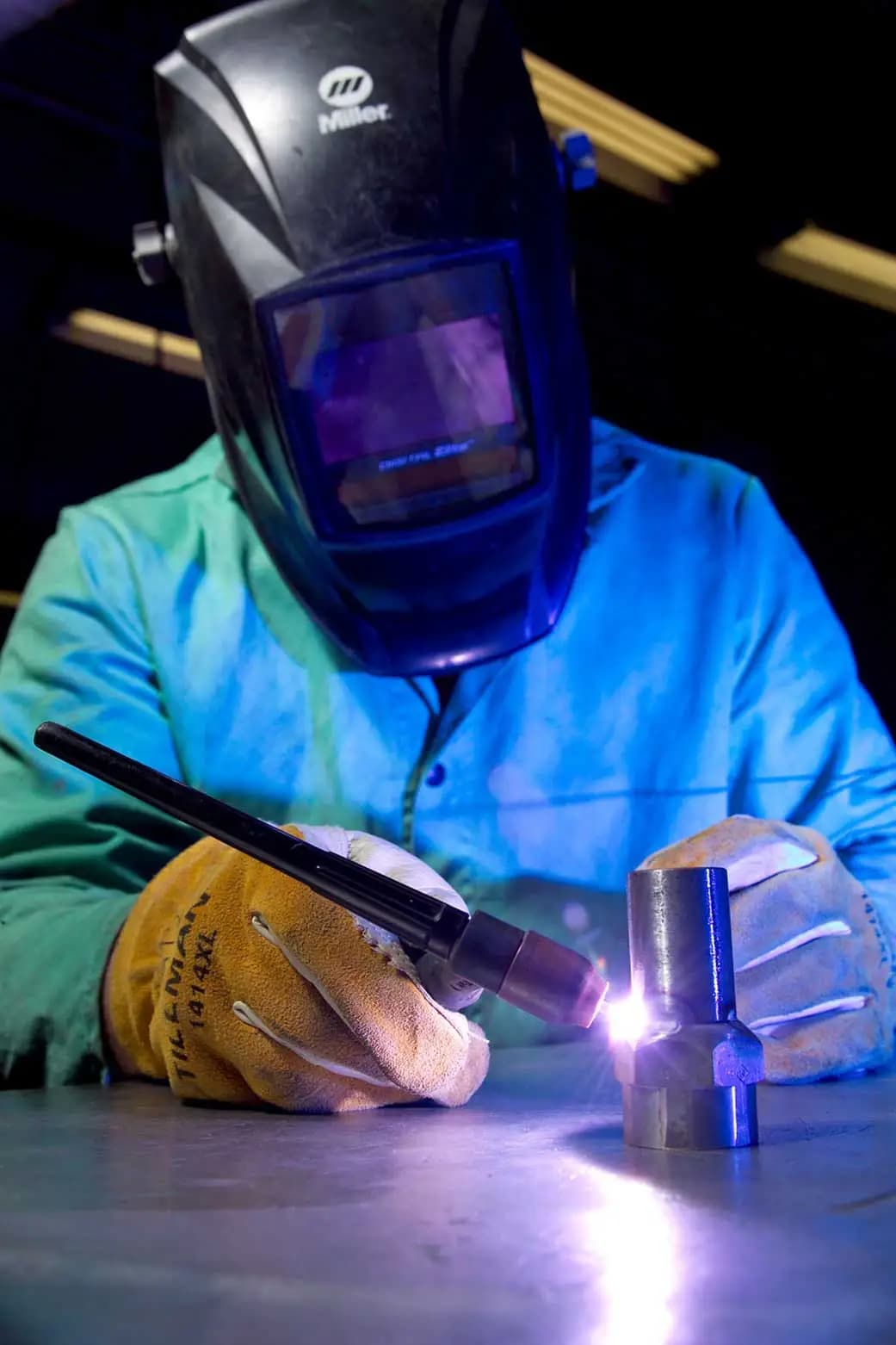 Welder performing gas tungsten arc welding