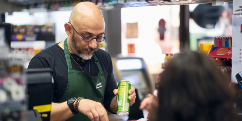 Store clerk checking out customers.