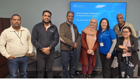 Image of WSPS staff with people at a Settlement Centre.