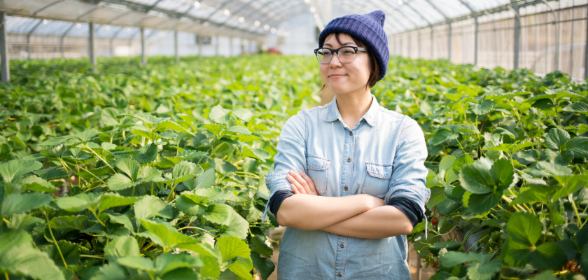 Portrait of a confident small business owner stood inside her farm with her arms crossed.