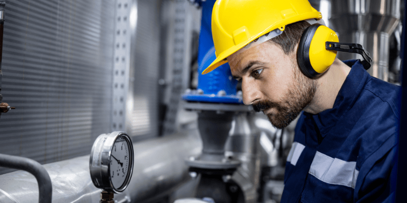 A worker in a plant wearing PPE.