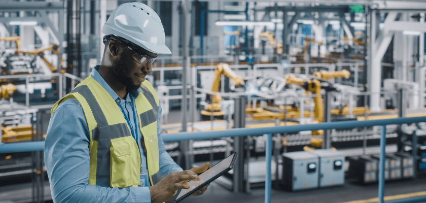 Worker in an Automotive Industrial Facility Working on Vehicle Production on Automated Technology Assembly Plant.