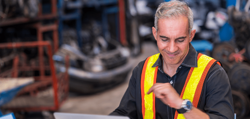 Workers inspecting auto parts in a warehouse.