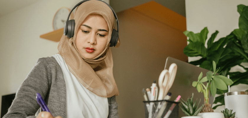 Woman watching a webinar in her office.