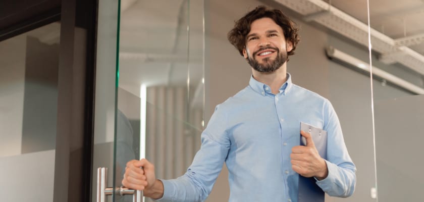 Smiling worker leaving their office.