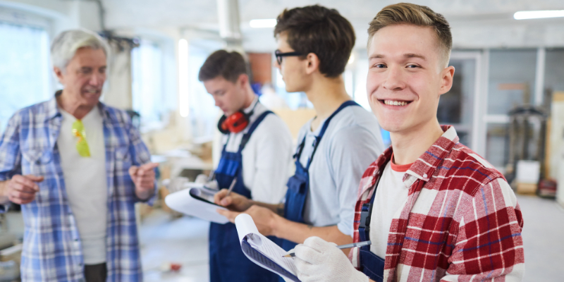 A supervisor training young workers.